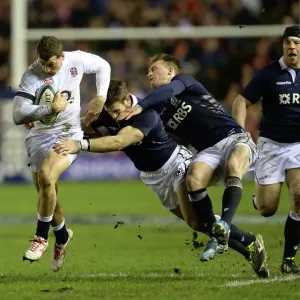 England's Jonny May runs with the ball as he evades a tackle England's Jonny May runs with the ball as he evades a tackle