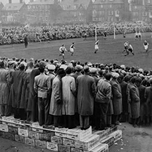 Fans standing on boxes to watch the FA Cup Tie at Great Yarmouth FC football ground 1953