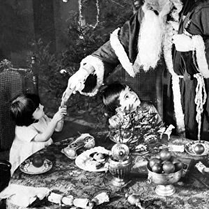 Father Christmas pulling a cracker, 1922
