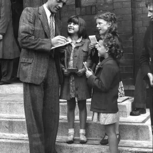 Footballer Eddie McMorran signing autographs 1947 Footballer Eddie McMorran signing autographs 1947