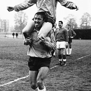 Footballer Nobby Stiles on the shoulders of fellow player Barry Bridges during England training 1965