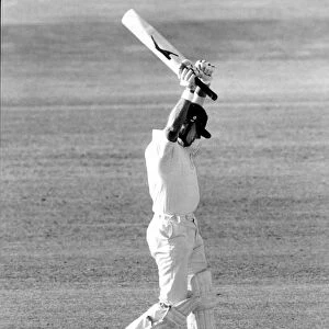 Geoff Boycott raises both arms to celebrate a Test century