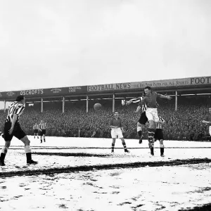 Geoff Thomas jumps high to head clear from Newcastle's centre forward Len White on a snow covered City Ground 1955 Geoff Thomas jumps high to head clear from Newcastle's centre forward Len White on a snow covered City Ground 1955