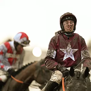 Harry Swan in the muddy last race on the Thursday evening in the last light of the day Cheltenham Festival week