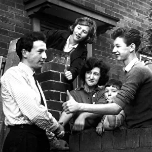 Huddersfield footballer Mike O'Grady is congratulated by neighbours at his Leeds home after being capped for England