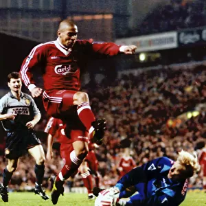Man Utd's keeper Peter Schmeichel dives to save from Stan Collymore
