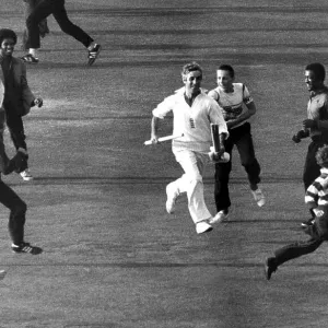 Mike Brearley runs off the pitch holding the cricket stumps Mike Brearley runs off the pitch holding the cricket stumps