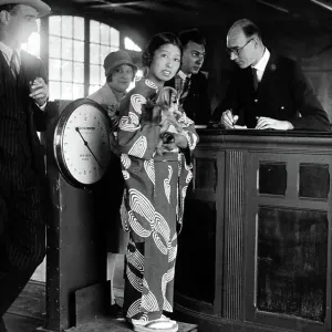 Miki, the Japanese artiste, standing with her dog on the scales at Le Bourget Airport, Paris 1928 Miki, the Japanese artiste, standing with her dog on the scales at Le Bourget Airport, Paris 1928