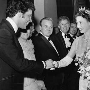 Queen Elizabeth II is presented to singer Tom Jones
