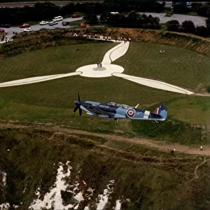 RAF Spitfire flies over the Battle of Britain Museum and Memorial at Capel-Le-Ferne in Dover, Kent
