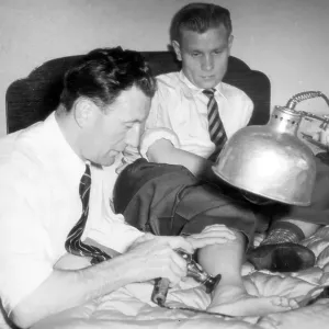 Sam Cowan massages Newcastle player Charlie Crowes injured foot