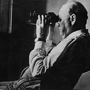 Sir Winston Churchill looking through a set of binocular