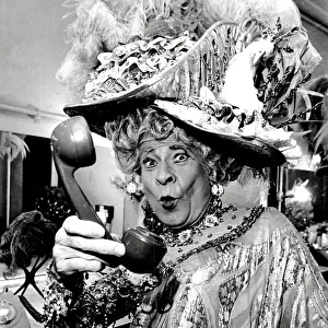 Stanley Baxter, dressed as a pantomime dame