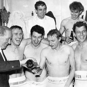 United's manager Matt Busby pours champagne for Denis Law as Pat Crerand, Pat Dunn and David Herd (1934-2016), with at the rear Shay Brennan and John Connelly look on United's manager Matt Busby pours champagne for Denis Law as Pat Crerand, Pat Dunn and David Herd (1934-2016), with at the rear Shay Brennan and John Connelly look on