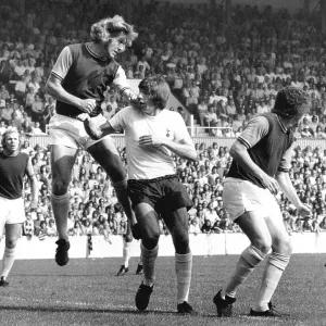 West Ham's Bobby Moore watches his team mate Tommy Taylor head the ball away from Tottenham's Martin Peters West Ham's Bobby Moore watches his team mate Tommy Taylor head the ball away from Tottenham's Martin Peters