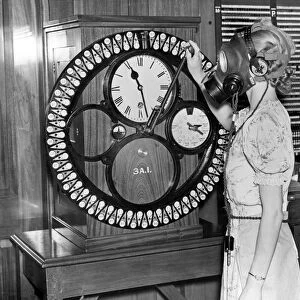Woman in gas mask clocks in at work