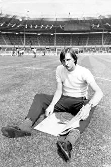 Pictures Prints: Ajax's leading goalscorer Johan Cryuff's relaxes whilst reading a magazine on the famous Wembley pitch 1971