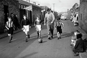 Images Dated 8th September 2023: Bobby Charlton plays football with children in his home town of Ashington