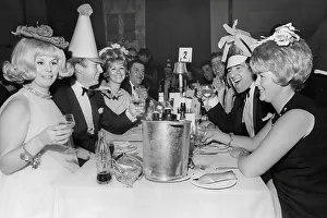 Famous Face Prints: Bobby Moore, and wife Tina Moore across the table from Terry Venables and his wife 1967 at a New Years Party