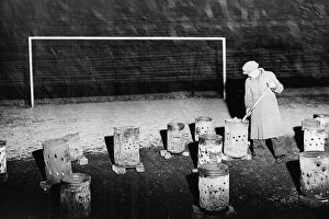 Christmas Football Collection: Braziers burning on the pitch at Burnden Park home of Bolton Wanderers 1938