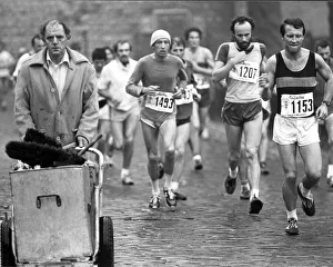 London Prints: Competitors in the first London Marathon in March 1981 run past an unimpressed street cleaner