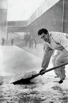 Images Dated 19th December 2023: Emilio Aldecoa Birmingham City trainer clearing snow from pitch