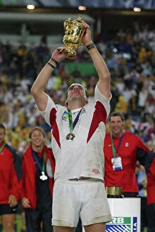 Images Dated 6th September 2023: England captain Martin Johnson lifts the Webb Ellis Trophy
