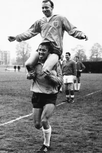 England Football Team Prints: Footballer Nobby Stiles on the shoulders of fellow player Barry Bridges during England training 1965