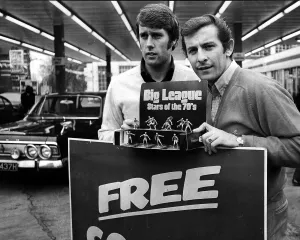 Geoff Hurst and Alan Mullery pose with football figurines in a garage in Acton in 1971