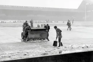 Liverpool F.C Prints: Groundsmen attempting to rid the pitch of ice at Anfield