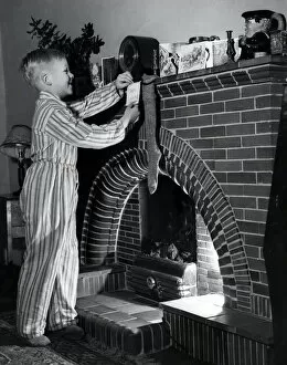 Christmas Past Collection: Hanging up his stocking, 1954
