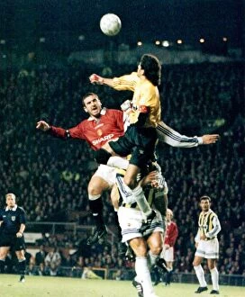 Manchester United Collection: Man Utd's Eric Cantona challenges Fenerbahce keeper, Rustu.