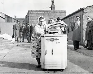 Mrs. Sarah Dewhirst taking away the washing machine from the Peel Park ground at Accrington Stanley, 1962