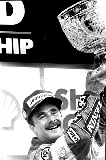 Motoring Prints: Nigel Mansell holds the trophy after winning the British Grand Prix at Silverstone