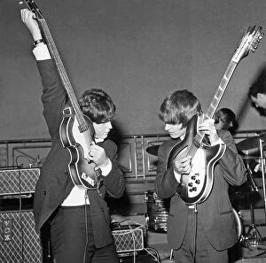 The Beatles Collection: Paul McCartney and George Harrison tune their guitars