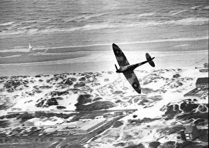 Aircraft Collection: An RAF Spitfire flies over the dunes of Dunkirk