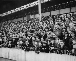 Football Grounds And Crowd Prints: A section of the crowd at a Tottenham v Millwall match in 1940