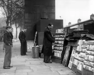 London Prints: Street trader selling postcards, Embankment, 1946