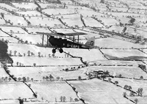 Aircraft Collection: A Tiger Moth over snow-covered countryside, 1927