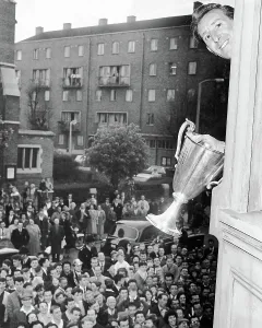 Tottenham Hotspur Prints: Tony Marchi waves the European Cup Winners Cup trophy from the Tottenham boardroom window 1963