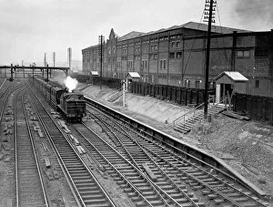 Manchester United Collection: Train passing Manchester United Football Ground, 1935