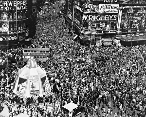 Forties Prints: VE Day Crowds bring traffic to a standstill in Piccadilly Circus with the boarded-up statue of Eros at its heart