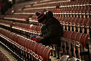 Welcome to Wrexham AFC - an early fan sitting reading the clubs programme hours before the game