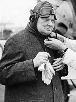 Images Dated 29th March 2018: Winston Churchill trying on a flying helmet