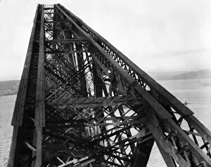 Images Dated 27th March 2023: A workman on a giant girder of the Forth Bridge in Scotland. 1931